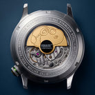 Close-up of AVI-8 Snoopy Automatic watch showing the open back case with a Snoopy rotor