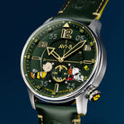 Close-up of AVI-8 Snoopy Limited Edition wristwatch featuring a dark green dial with Charlie Brown, Snoopy and Woodstock cartoon characters