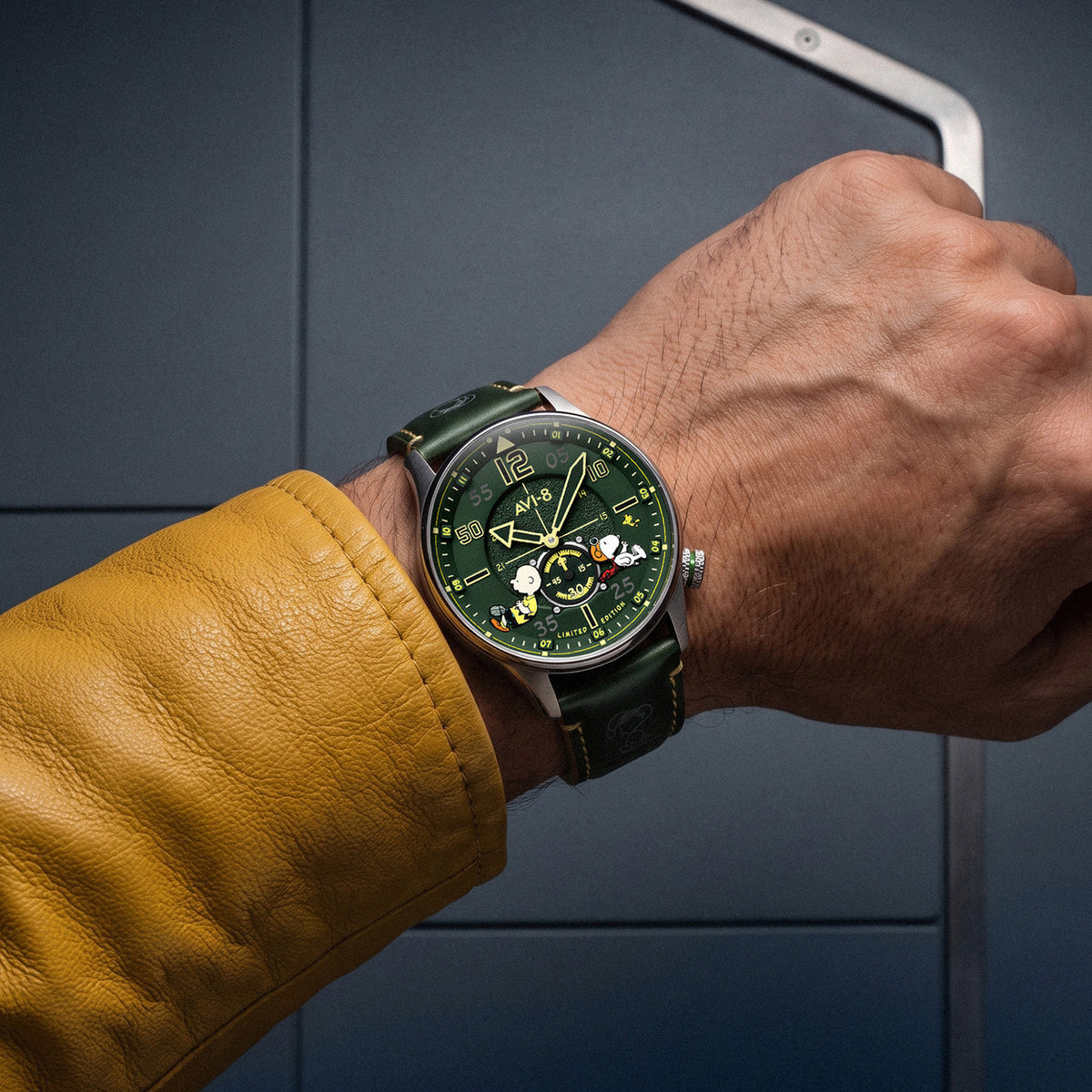 Wrist shot of AVI-8 Peanuts Snoopy watch with dark green dial and leather strap