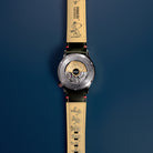 AVI-8 Peanuts Snoopy Limited Edition watch, Desert Shadow AV-4155-04, Back view showing open caseback and Snoopy characters on the strap lining