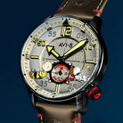 Close-up of AVI-8 Snoopy Limited Edition wristwatch featuring a sand dial with Charlie Brown, Snoopy and Woodstock cartoon characters